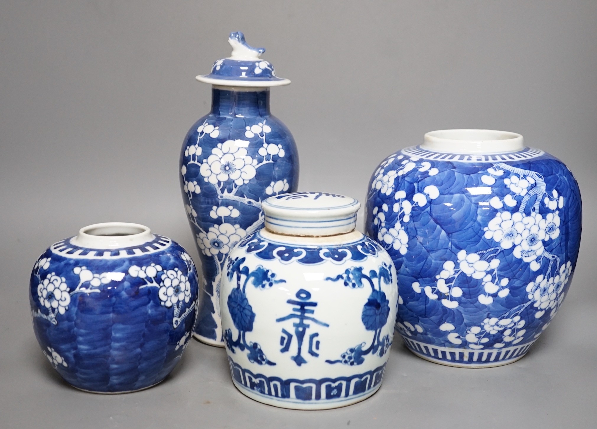 Two Chinese prunus jars, a vase and cover and a a jar and cover, vase and cover 26 cms high